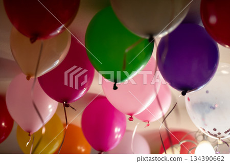 Clusters of glossy helium balloons in soft and bright shades set cheerful party scene 134390662