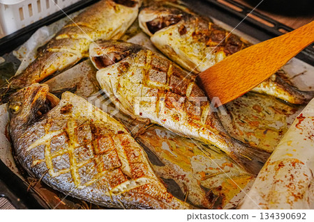 Oven-Cooked Dorado Fish Ready to Serve on Tray Oven-Cooked Dorado Fish Ready to Serve on Tray 134390692