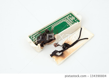 Burned and melted electronic power supply circuit after electrical short circuit isolated on white. Burned and melted electronic power supply circuit after electrical short circuit isolated on white. 134390804