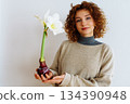 young woman with an amaryllis flower 134390948