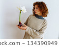 young woman with an amaryllis flower 134390949