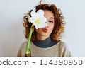 young woman with an amaryllis flower 134390950