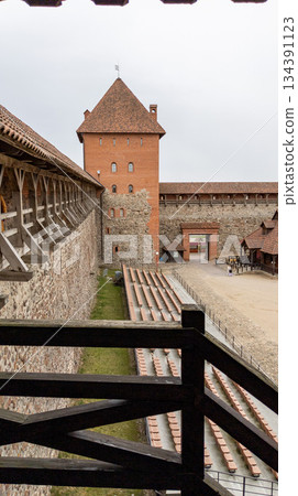 Tower and balustrade of the inner courtyard of the Lida medieval castle. Tourist attraction. Vertical orientation 134391123