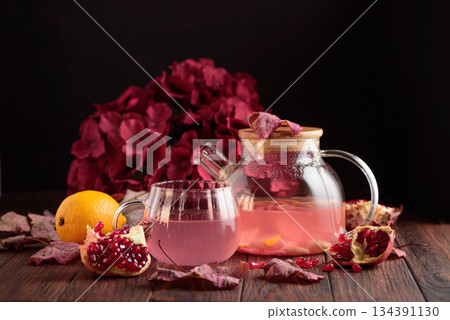 Autumn Beverage: Pomegranate Tea with Lemon and Ginger on Rustic Table Autumn Beverage: Pomegranate Tea with Lemon and Ginger on Rustic Table 134391130