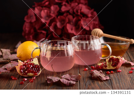Autumn Beverage: Pomegranate Tea with Lemon and Ginger on Rustic Table Autumn Beverage: Pomegranate Tea with Lemon and Ginger on Rustic Table 134391131