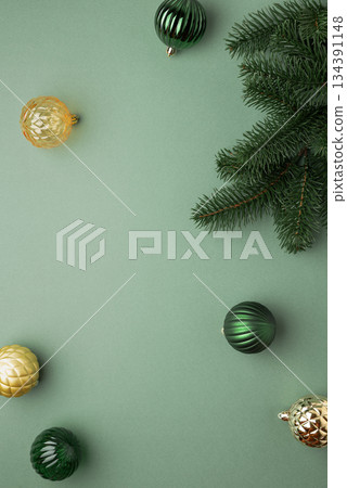 Fir Tree Branch with Green and Golden Christmas Ornaments on Green Background in Festive Flat Lay Fir Tree Branch with Green and Golden Christmas Ornaments on Green Background in Festive Flat Lay 134391148
