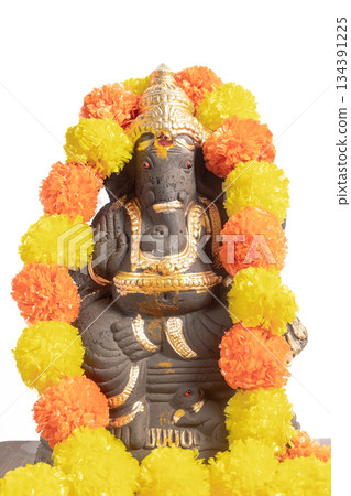 Clay Ganesha idol with bright marigold garland for Hindu rituals and festivals. 134391225