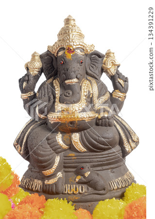 Gold decorated Ganesha idol with marigold flowers, for Ganesha Chaturthi worship 134391229