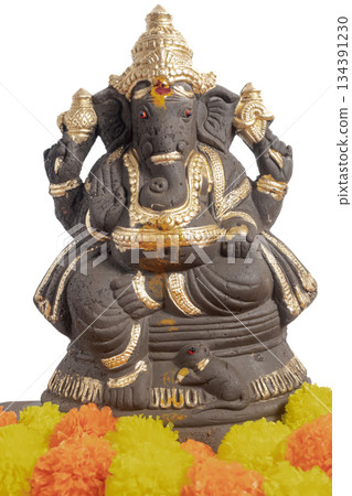 Ganesha idol with gold decoration and marigold garland for Hindu festival celebration 134391230