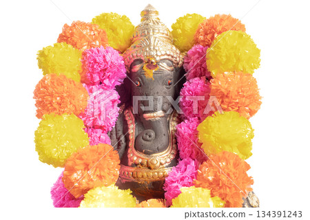 A Ganesha idol decorated with a bright floral garland for Ganesha Chaturthi. 134391243