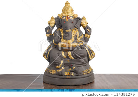 Ganesha idol adorned with gold color decoration for Ganesh Chaturthi. 134391279