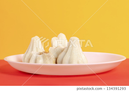 Steamed sweet modak rice dumplings on a white plate Steamed sweet modak rice dumplings on a white plate 134391293