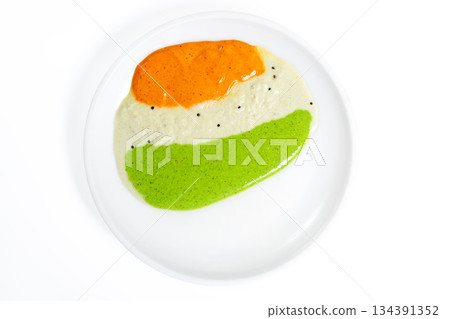 Tricolor chutney spread on a white plate, South Indian food concept 134391352