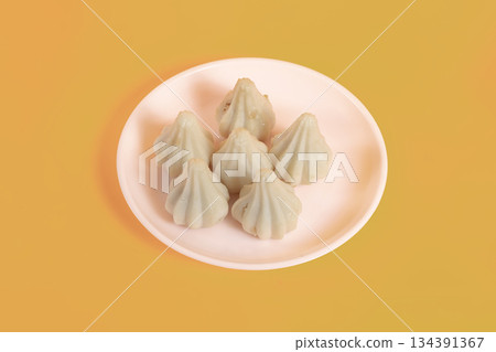 Six steamed sweet modak rice dumplings for Ganesh festival Six steamed sweet modak rice dumplings for Ganesh festival 134391367