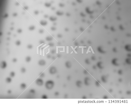 Abstract Gray Blurred Bokeh Lights Background Texture. Monochrome blurred abstract background with soft dark circular bokeh spots on gray. Ideal for modern neutral overlays and designs. Abstract Gray Blurred Bokeh Lights Background Texture. Monochrome blurred abstract background with soft dark circular bokeh spots on gray. Ideal for modern neutral overlays and designs. 134391481
