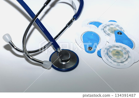 Medical electrodes and stethoscope symbolizing heart health checkup. 134391487