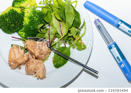 Medical diet concept featuring tuna salad broccoli and ozempic 134391494