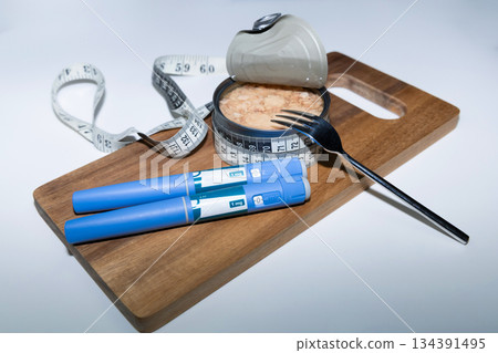 Healthy diet concept with tuna can and ozempic pen. Healthy diet concept with tuna can and ozempic pen. 134391495