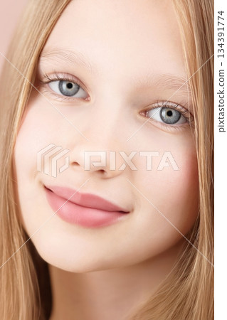 Face. Portrait of a funny smiling young girl. Blonde Caucasian girl with blue eyes isolated on pink background. Advertising beauty concept skin care for teenagers. Haircare. Self care Gen Alpha 134391774