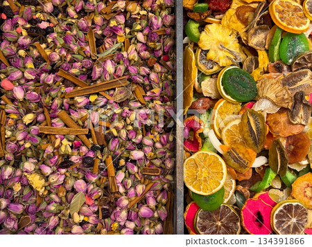 Dried rosebuds mixed with cinnamon sticks forming a dense herbal tea surface in Istanbul bazaar. Floral infusions, aromatic rituals, and botanical wellness traditions expressed through color, texture Dried rosebuds mixed with cinnamon sticks forming a dense herbal tea surface in Istanbul bazaar. Floral infusions, aromatic rituals, and botanical wellness traditions expressed through color, texture 134391866