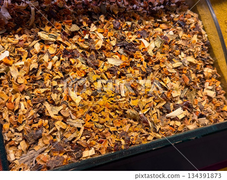 Mixed dried vegetable and spice flakes creating a rustic textured composition in Istanbul bazaar. Homemade seasoning, layered flavors, and traditional cooking practices conveyed through irregular 134391873