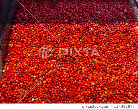 Red peppercorns densely covering a spice tray in a vivid textured layer in Istanbul bazaar. Culinary seasoning, aromatic intensity, and global cooking traditions highlighted through color and Red peppercorns densely covering a spice tray in a vivid textured layer in Istanbul bazaar. Culinary seasoning, aromatic intensity, and global cooking traditions highlighted through color and 134391875