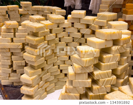 Neutral toned soap bars stacked in layered rows forming a textured wall display. Minimalist skincare, handmade production, and orderly presentation highlighting purity, routine, and everyday self care Neutral toned soap bars stacked in layered rows forming a textured wall display. Minimalist skincare, handmade production, and orderly presentation highlighting purity, routine, and everyday self care 134391892