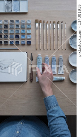 Top view artist workspace with blue art supplies 134391919