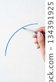 Hand painting blue arc on white paper 134391925