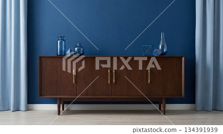 Dark wood sideboard, blue interior wall Dark wood sideboard, blue interior wall 134391939
