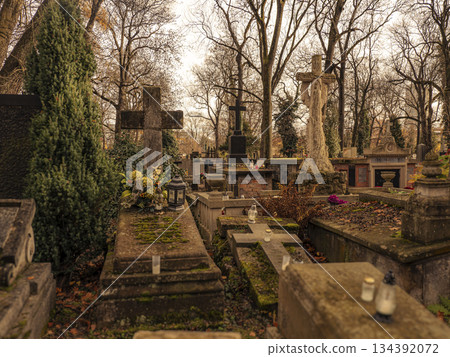 Autumn Cemetery Scene With Mossy Tombstones, Crosses, and Serene Tombs in Quiet Grounds 134392072