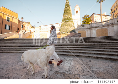 oman walking with dog near the Spanish Steps in Rome during holiday season oman walking with dog near the Spanish Steps in Rome during holiday season 134392357
