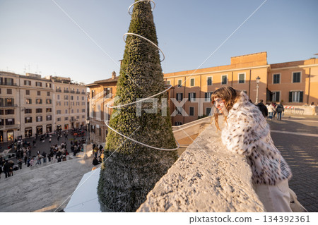 Smiling woman enjoying festive city view in Rome during holiday season 134392361
