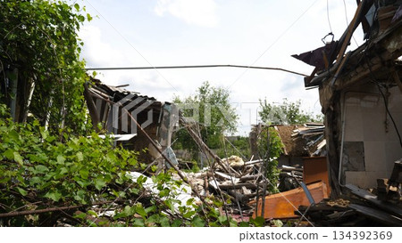 View to destroyed residential buildings at Kharkivska oblast. Ruined houses after bomb attacks on ukrainian territory from russia army. Consequences of russian invasion of Ukraine. Slow motion 134392369