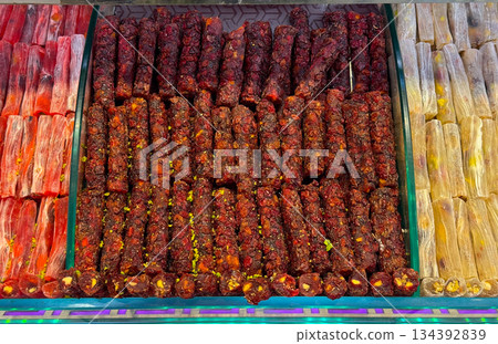 Fruit and nut rolls arranged in a Istanbul bazaar. Traditional sweets, artisanal craft, and cultural indulgence presented through structured confectionery layout. Fruit and nut rolls arranged in a Istanbul bazaar. Traditional sweets, artisanal craft, and cultural indulgence presented through structured confectionery layout. 134392839
