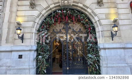 Festive holiday entrance with Christmas decorations and elegant architecture Festive holiday entrance with Christmas decorations and elegant architecture 134392898