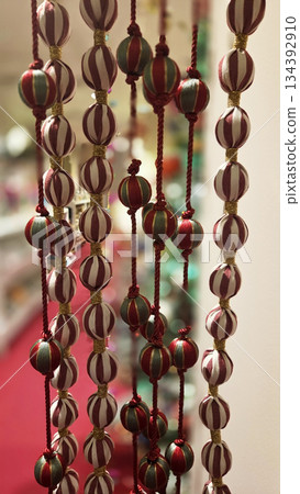 Festive christmas and new year decorations with hanging ornaments for holiday ambiance. Vertical banner. Copy space Festive christmas and new year decorations with hanging ornaments for holiday ambiance. Vertical banner. Copy space 134392910