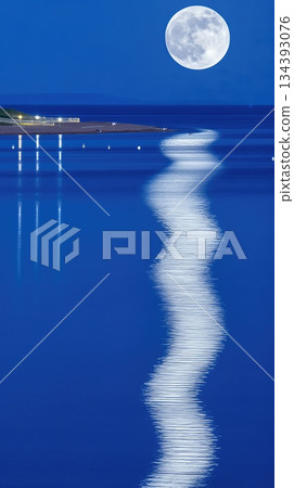 Moonlight Reflecting on Calm Water Creates a Serene Atmosphere at Night by the Beach Shore Moonlight Reflecting on Calm Water Creates a Serene Atmosphere at Night by the Beach Shore 134393076