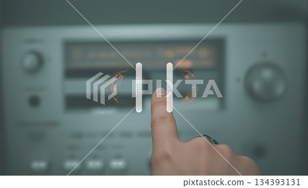 Vintage Cassette Tape Showcased With a Finger Pressing Pause on a Retro Audio Player Vintage Cassette Tape Showcased With a Finger Pressing Pause on a Retro Audio Player 134393131