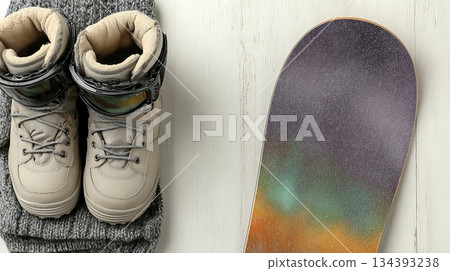 Equipment for Snowboarding Displayed in Flat Lay Style With Boots and a Vibrant Snowboard Equipment for Snowboarding Displayed in Flat Lay Style With Boots and a Vibrant Snowboard 134393238