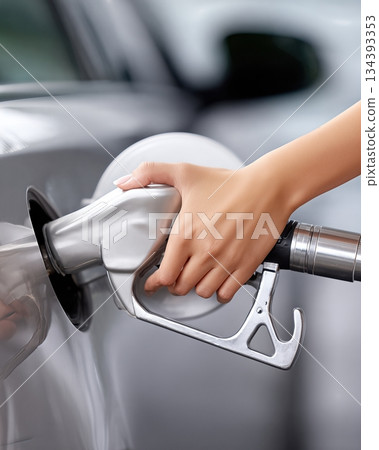 Person Fills Car With Fuel at a Gas Station During Daylight Person Fills Car With Fuel at a Gas Station During Daylight 134393353
