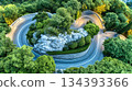 Winding Asphalt Road Through Lush Mountains Offers Scenic Views and Adventurous Driving Experience 134393366