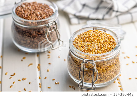 Golden linseed or flaxseed. Healthy flax seed in jar on white table. 134393442