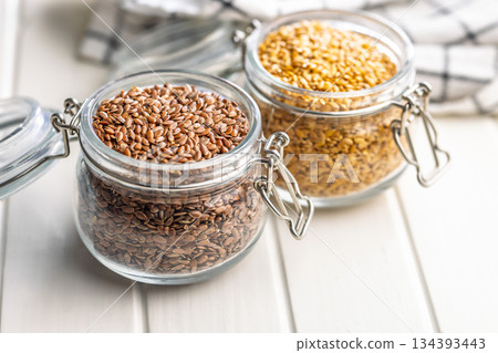 Linseed or flaxseed. Healthy flax seed in jar on white table. 134393443