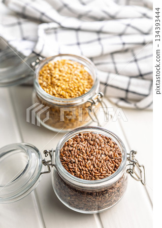 Linseed or flaxseed. Healthy flax seed in jar on white table. Linseed or flaxseed. Healthy flax seed in jar on white table. 134393444