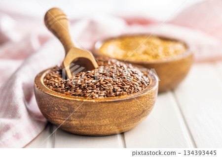 Linseed or flaxseed. Healthy flax seed in bowl on white table. Linseed or flaxseed. Healthy flax seed in bowl on white table. 134393445