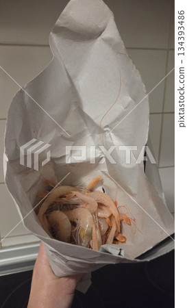 Fresh shrimps wrapped in paper for culinary delight and seafood cuisine inspiration Fresh shrimps wrapped in paper for culinary delight and seafood cuisine inspiration 134393486
