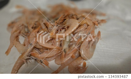 Fresh shrimps piled on surface perfect for seafood cuisine and restaurant menu design Fresh shrimps piled on surface perfect for seafood cuisine and restaurant menu design 134393487