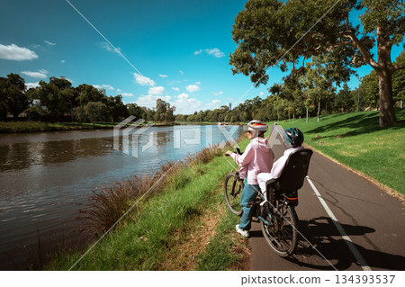 A scenic and enjoyable bike ride along the riverside with dear companions 134393537