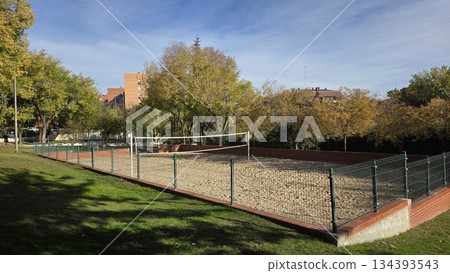 Outdoor beach volleyball court in urban park setting for recreation 134393543